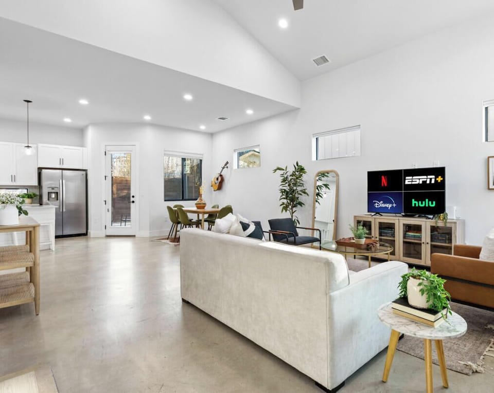 Living room with plenty of seating options, natural light, smart tv, and sleeper sofa