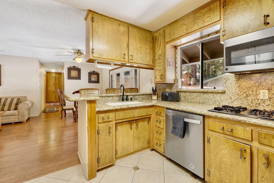Fully equipped cabin kitchen with ample cabinetry, stove, fridge, microwave, and coffee maker—perfect for cooking meals, morning coffee, and feeling right at home on your stay.
