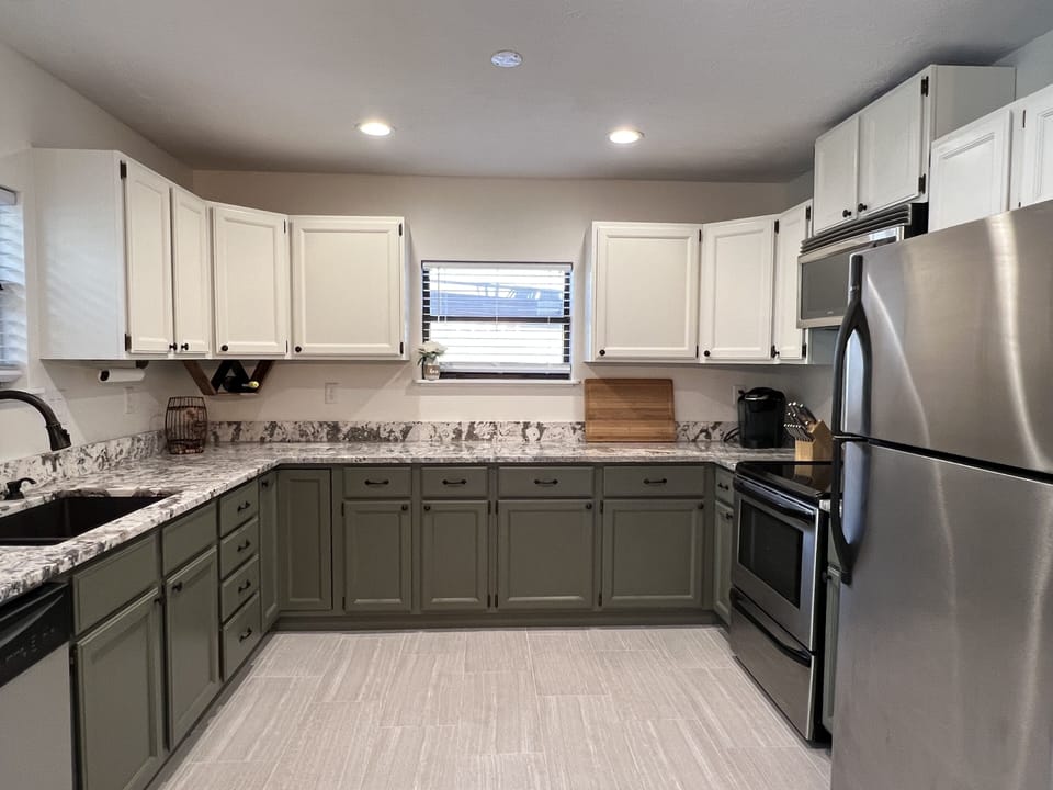 Refrigerator, oven, electric stove, microwave, Keurig, toaster. 
