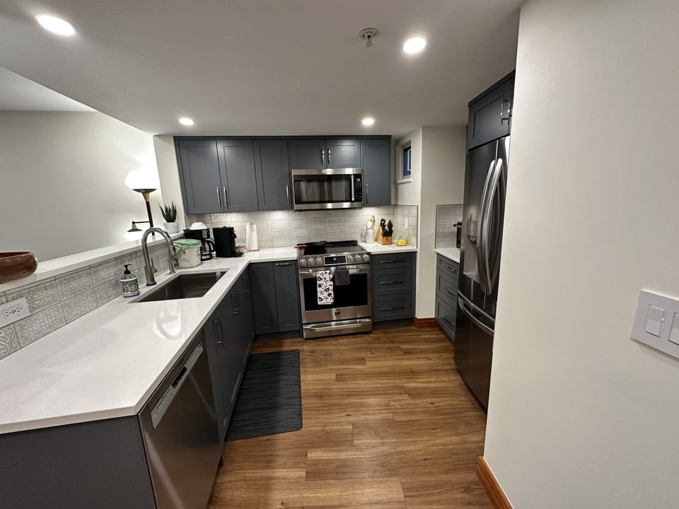 An upscaled Taylorreiko Design kitchen with all stainless steel appliances.