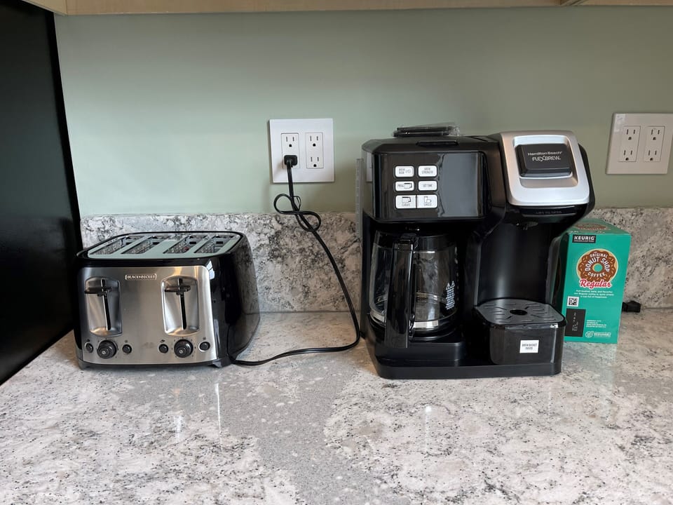 Kitchen appliances include coffee maker, toaster, mixer, blender, food processor