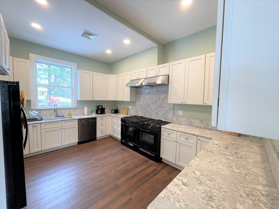 Chef's kitchen with extensive quartz counter tops, two ovens, 12 burners.