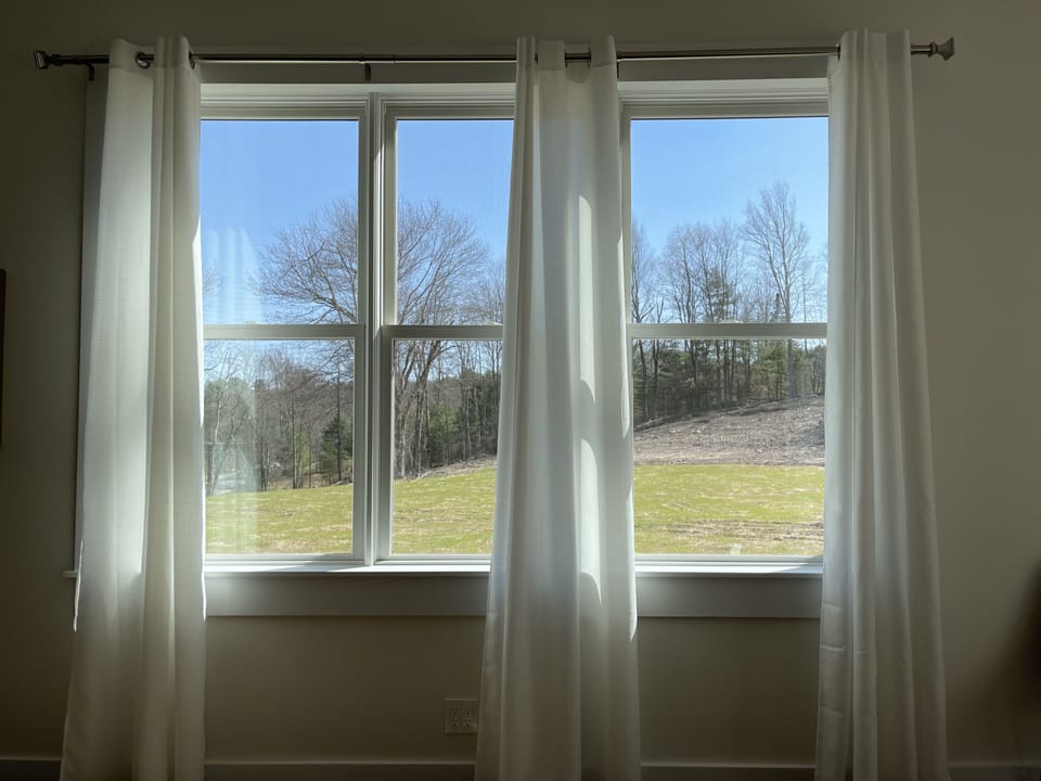 Living room windows overlook the 5 acre southern lawn. 
