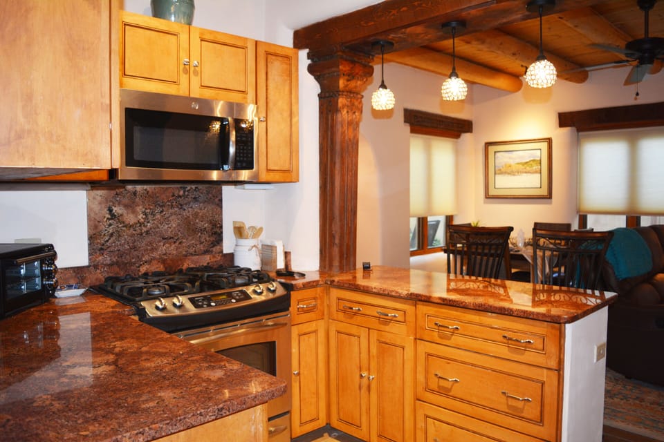 View from fully equipped kitchen to living and dining area
