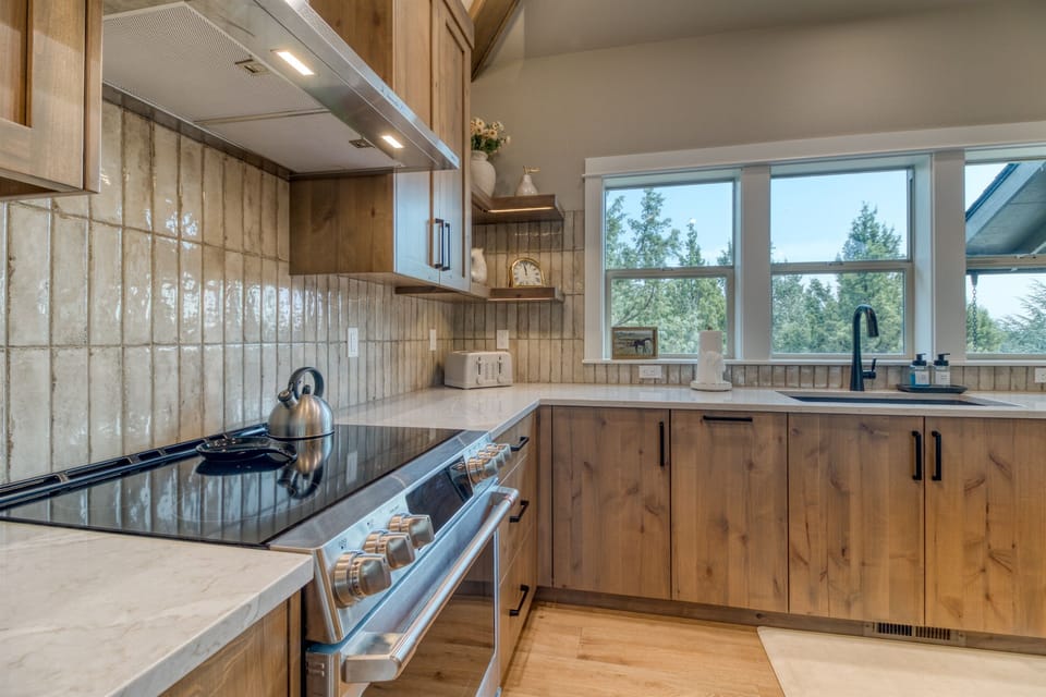 Gorgeous finishes in our brand new kitchen with glass cooktop & alder cabinetry.