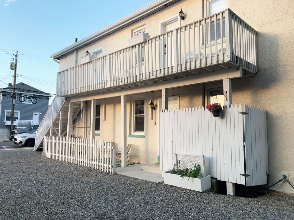 Charming exterior with private entry, balcony, and easy on-site parking