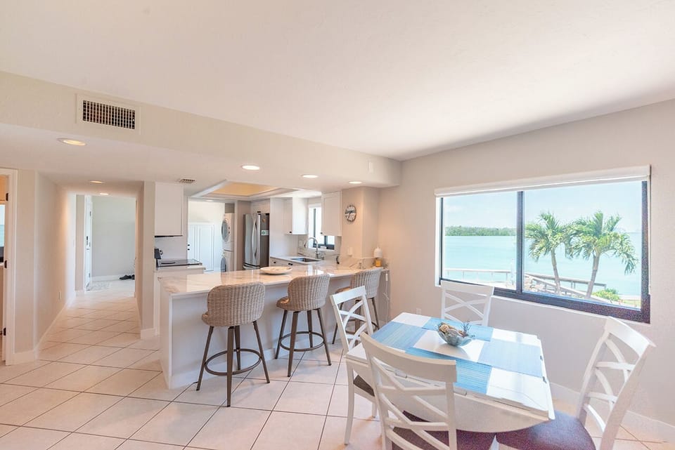 In addition to the dining area out on the Lanai, there is a Dining Table for 4 by the window with a beautiful view of the Bay and 3 seats at the Breakfast Bar
