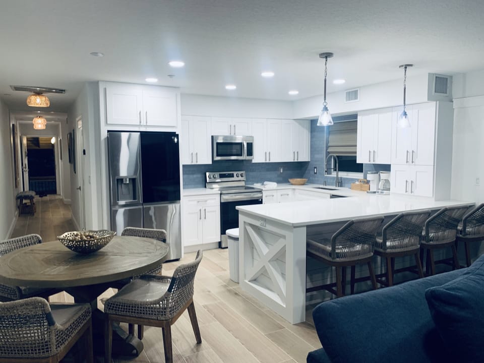 Kitchen with new appliances and spacious bar area. Open plan living and kitchen.