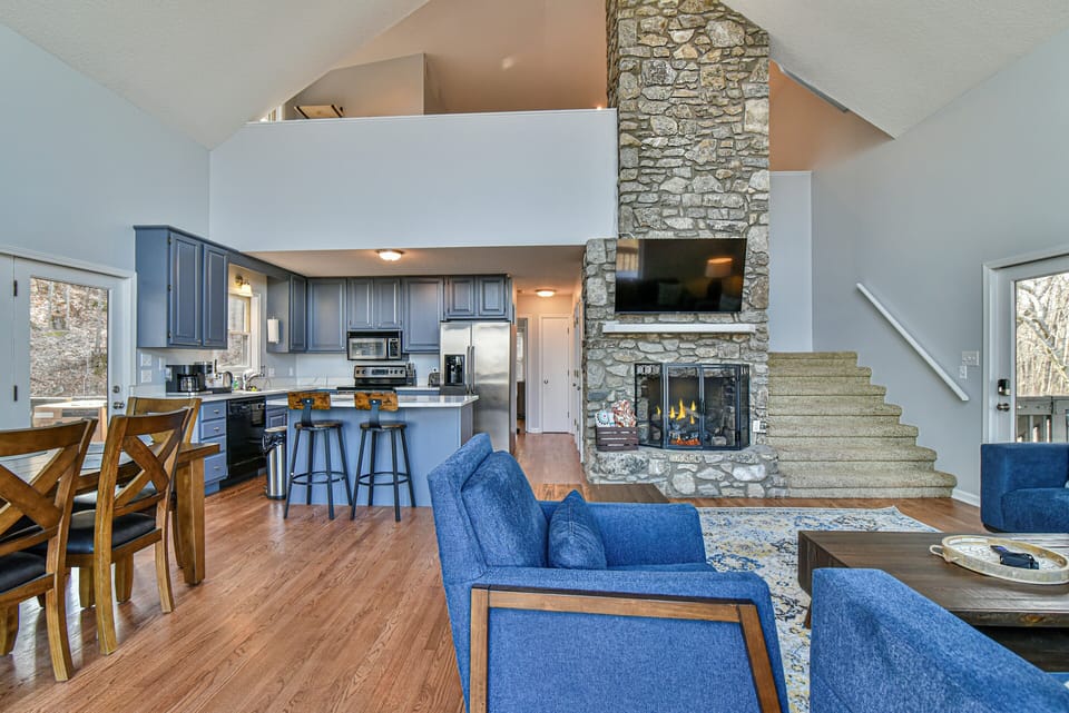 Cathedral ceiling with a beautiful stone fireplace running through the house