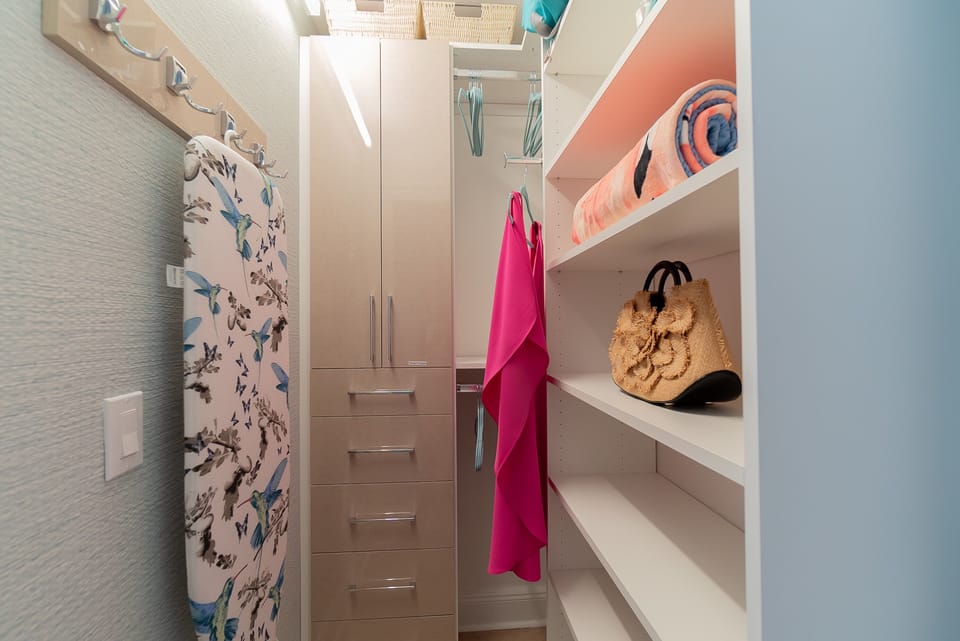 Gorgeous custom wallpapered closet.  Shelves, drawers, hooks and hanging space for your wardrobe.