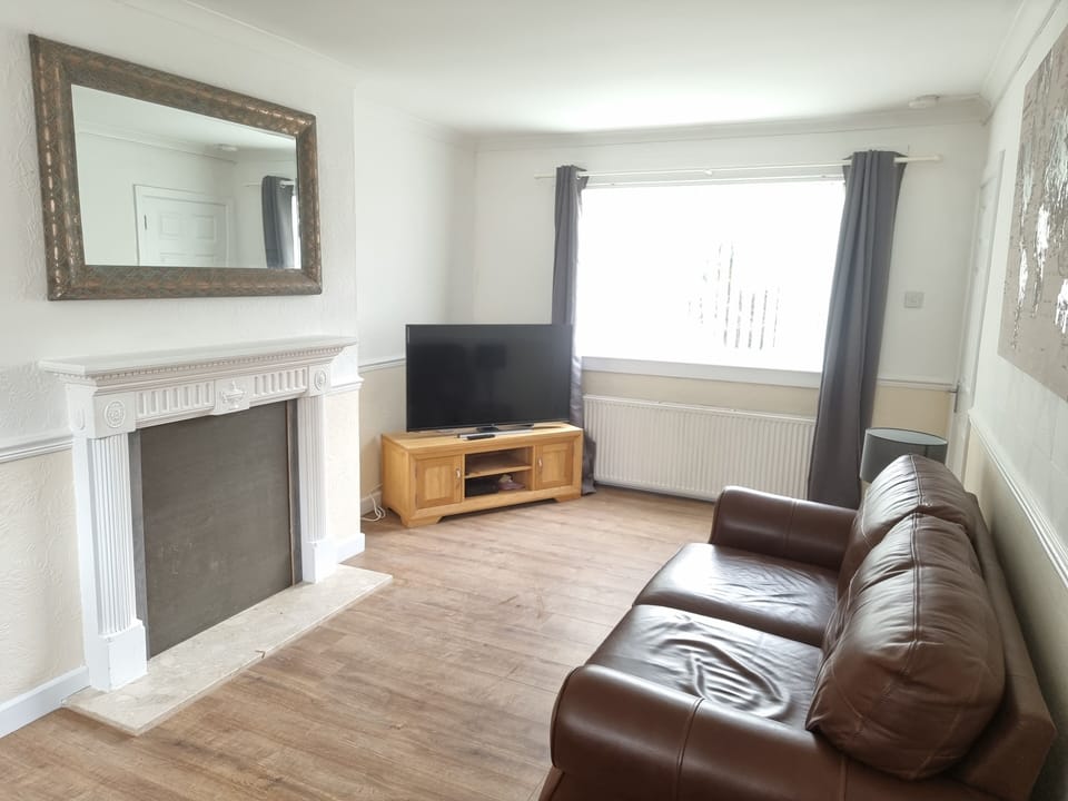 Living room with a view of the TV which is a large 50" 4K model 