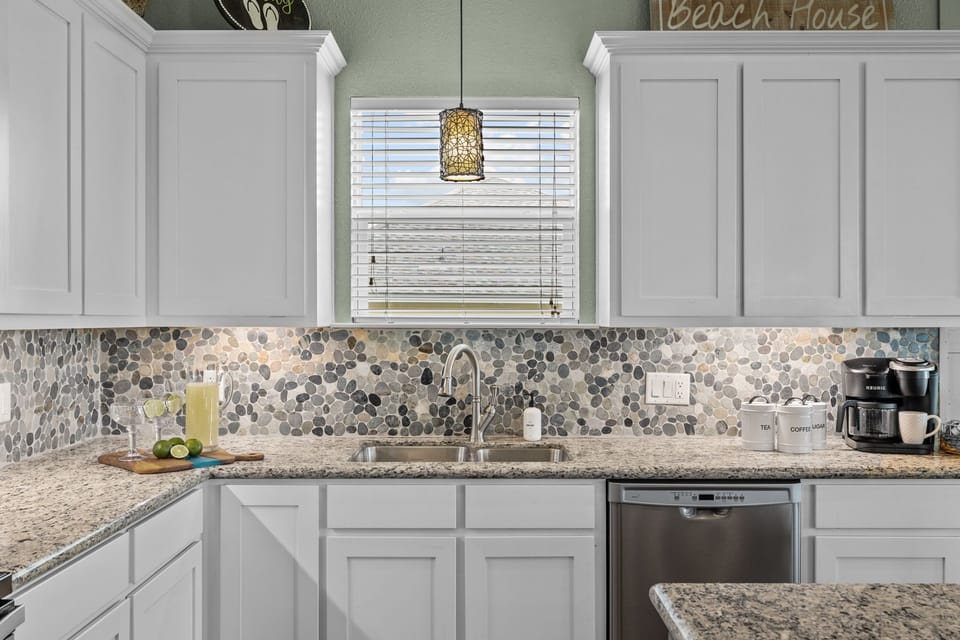 Bright and open kitchen space with many things provided such as hand soap.