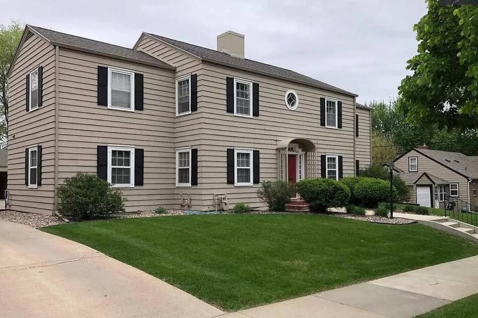 Front Entrace w/security door, lighting, garage and off-street parking behind