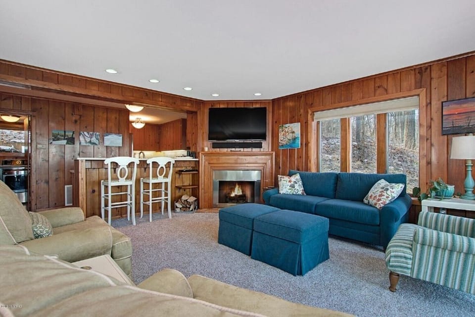 Family room, fireplace and dish tv.  Laundry room and Kitchen in background.