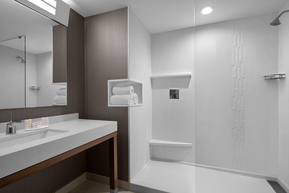 Refresh under a rainfall shower in a sleek, spa-like bath