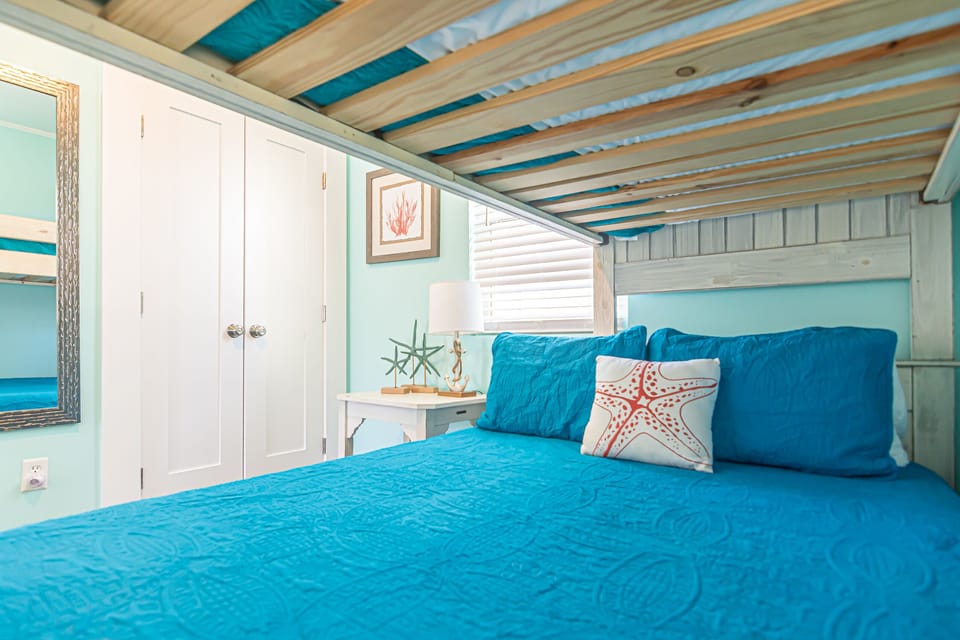 Twin over full bunk bed with upgraded sheets, hybrid mattresses, and luxury pillows.