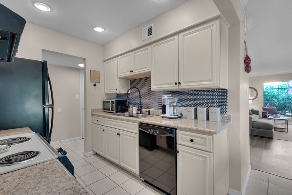 The kitchen opens into the dining room and entry hall.