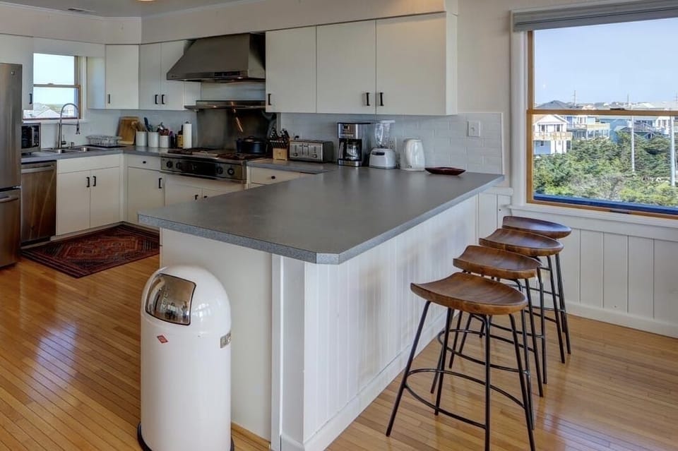 Kitchen with breakfast bar, pantry, and sunset view. 