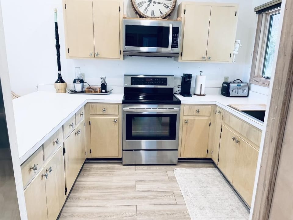 Open Concept Kitchen with bar seating and stainless-steel appliances 