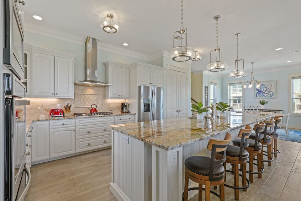 Giant kitchen island and 5 top gas stove and double oven 