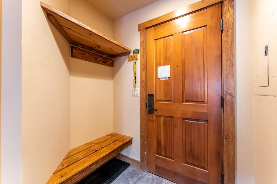 Step into your private entryway where warm wood details create a welcoming first impression, with thoughtful storage for your belongings.