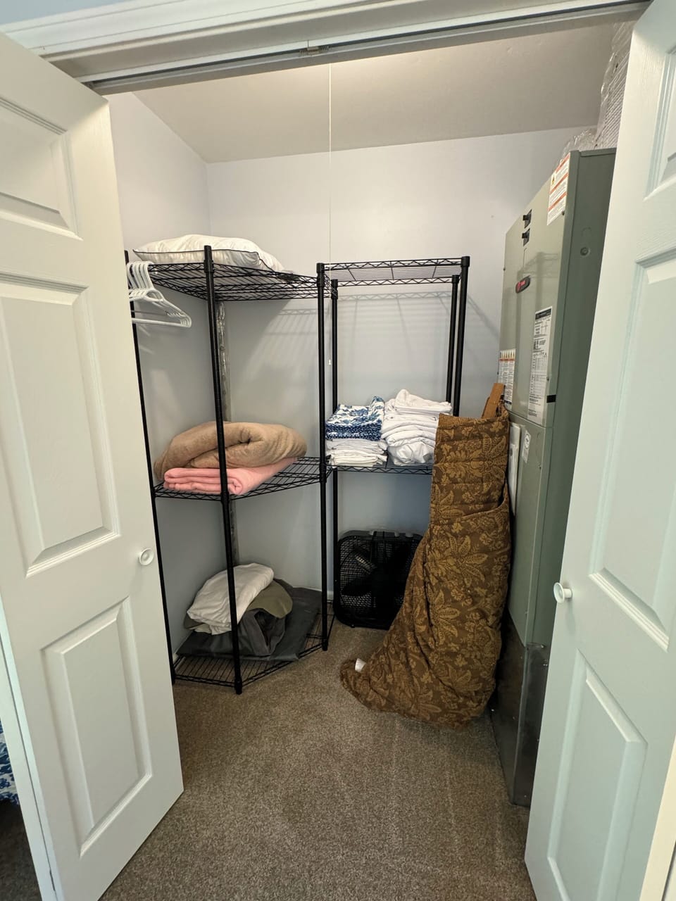 Bedroom #2-closet with extra linens & blankets, fan, hangers