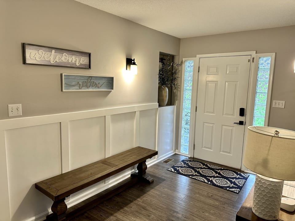 Inviting entryway with access to the garage, lower deck, and lake