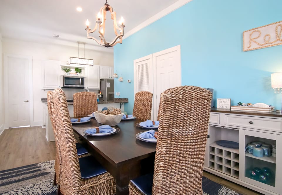 Dining area with coffee bar & shared half bath — open-plan and bright