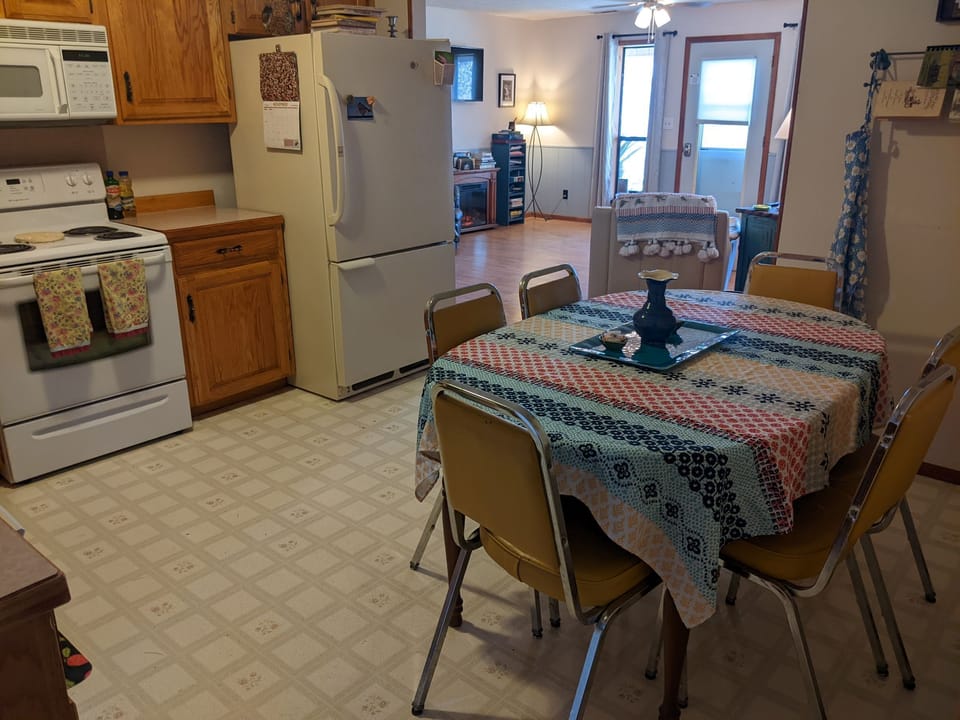 Kitchen with stove/oven, dishwasher, utensils & cook items, adjustable table