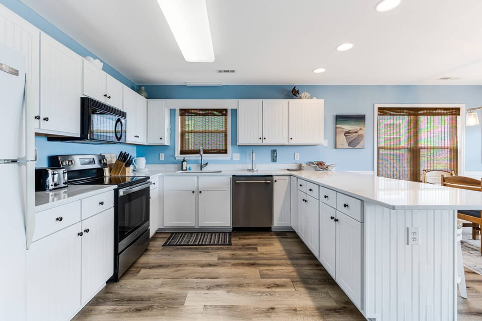 Large open kitchen & adjacent dining area, flooded with natural light, makes cooking, serving & cleanup easy & quick.