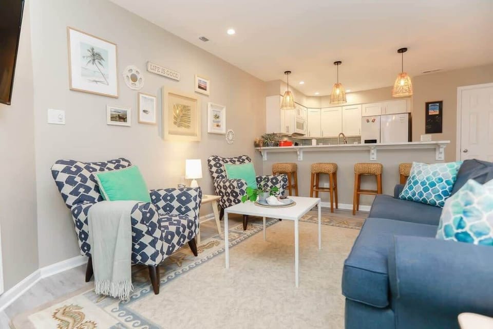 Living room is open to the kitchen breakfast bar with seating for four.