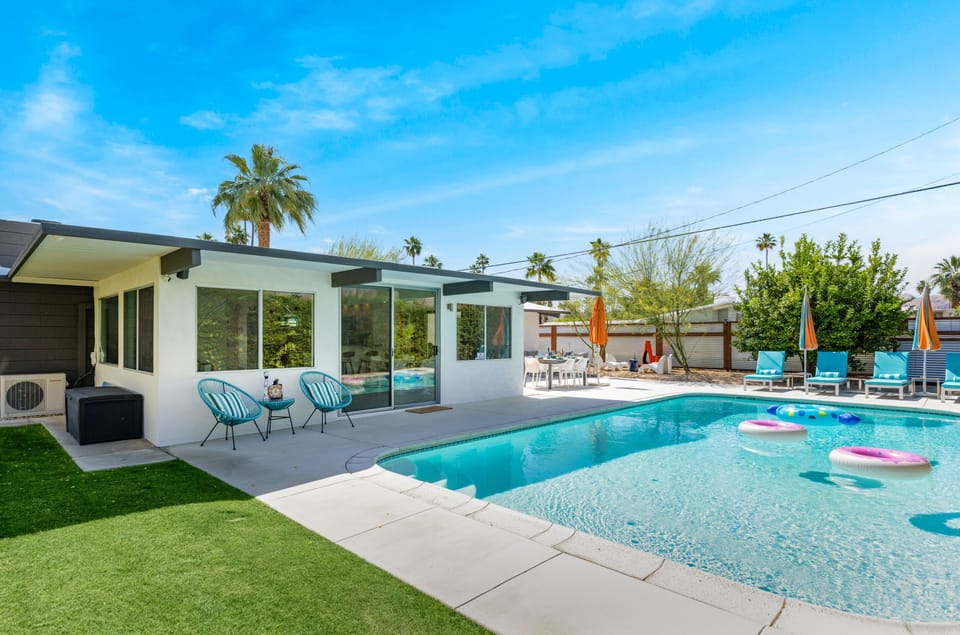 Enjoy a beautiful pool area surrounded by a vibrant desert garden