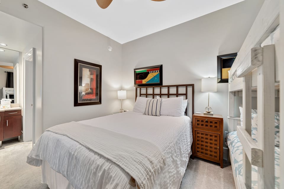 This interior showcases efficient space utilization with a stylish bunk bed arrangement and ensuite bathroom. The thoughtful design maximizes comfort and functionality, creating a versatile room.