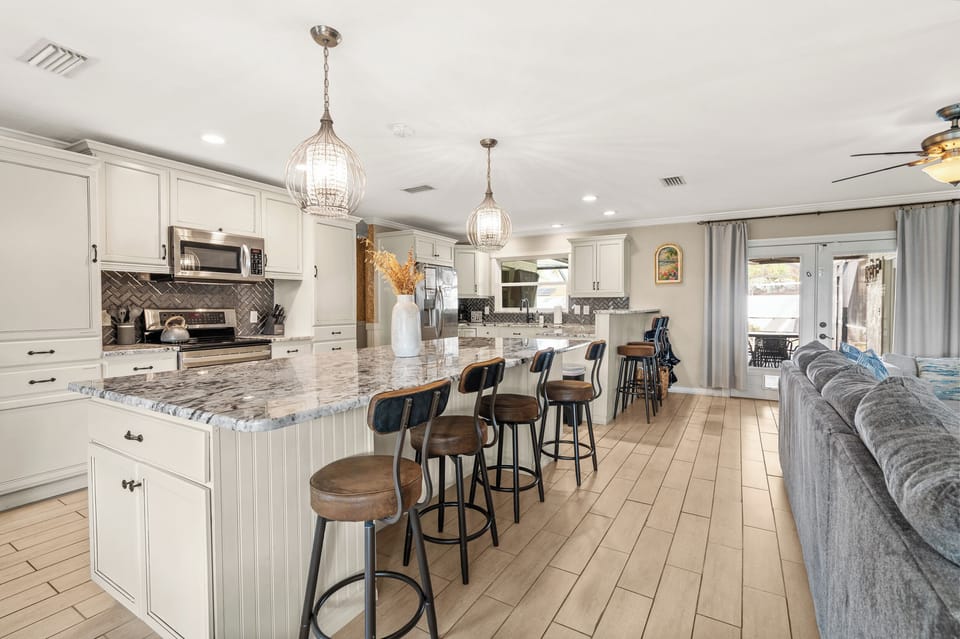 Large kitchen island lined with barstools is a great setting for whipping up the perfect vacation dinner!