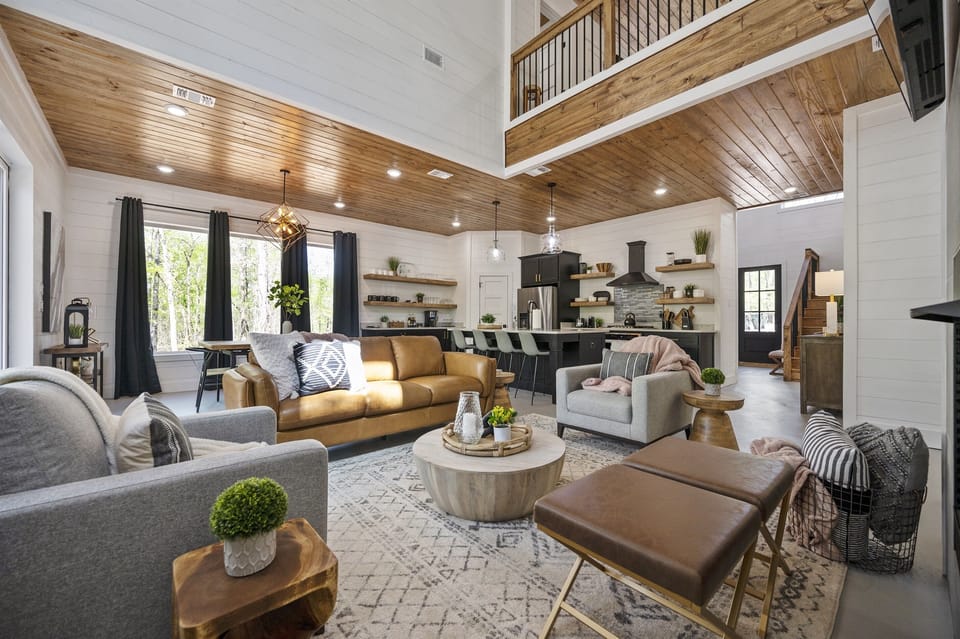 Living Room: Stunning space with high ceilings, stylish decor, and a view for relaxation!