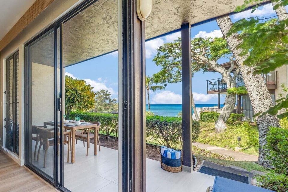 Inviting patio with dining area and clear views of the ocean horizon, perfect for relaxing outdoors