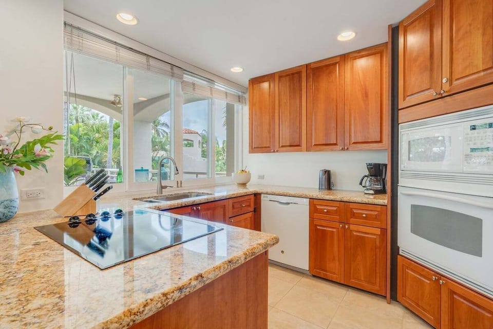 Modern kitchen with granite island and garden outlook
