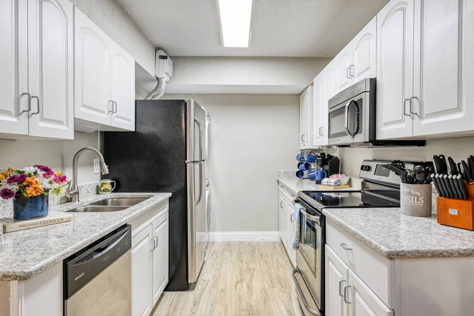 The kitchen includes stainless steel appliances.