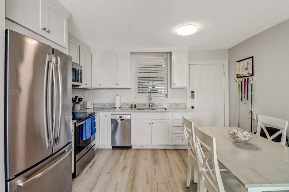 The freshly updated kitchen is equipped with granite counters, full size appliances and a farmhouse sink.