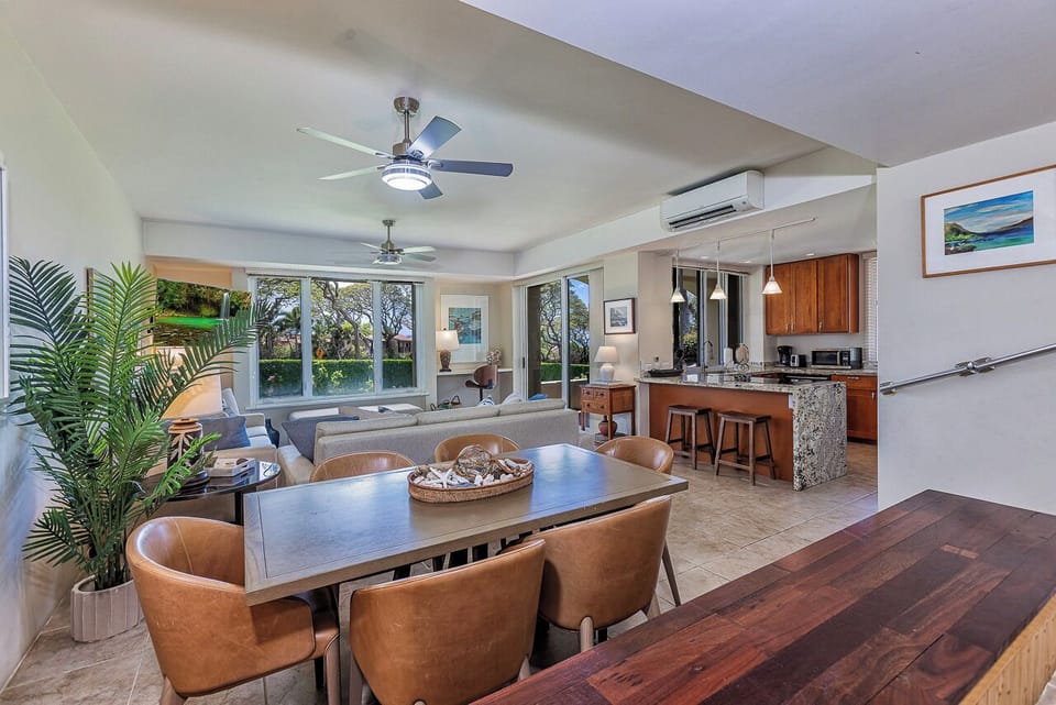 Step into your tropical retreat where natural light floods the open living space, inviting you to relax at the dining table or unwind in the lounge while soaking in peaceful garden views through expansive windows.