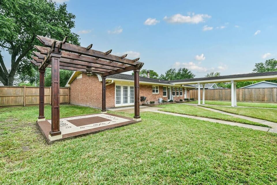 Back entrance; spacious, fully gated back yard, equipped with grill, a folding tables and chairs