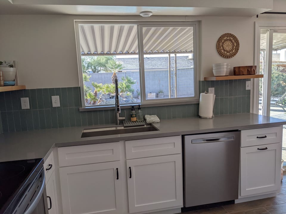 Kitchen views the backyard and pool.