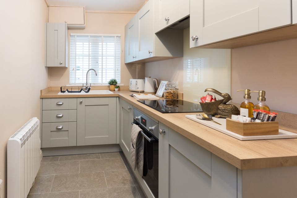 Kitchen with all utensil. washing machine fridge & oven.
