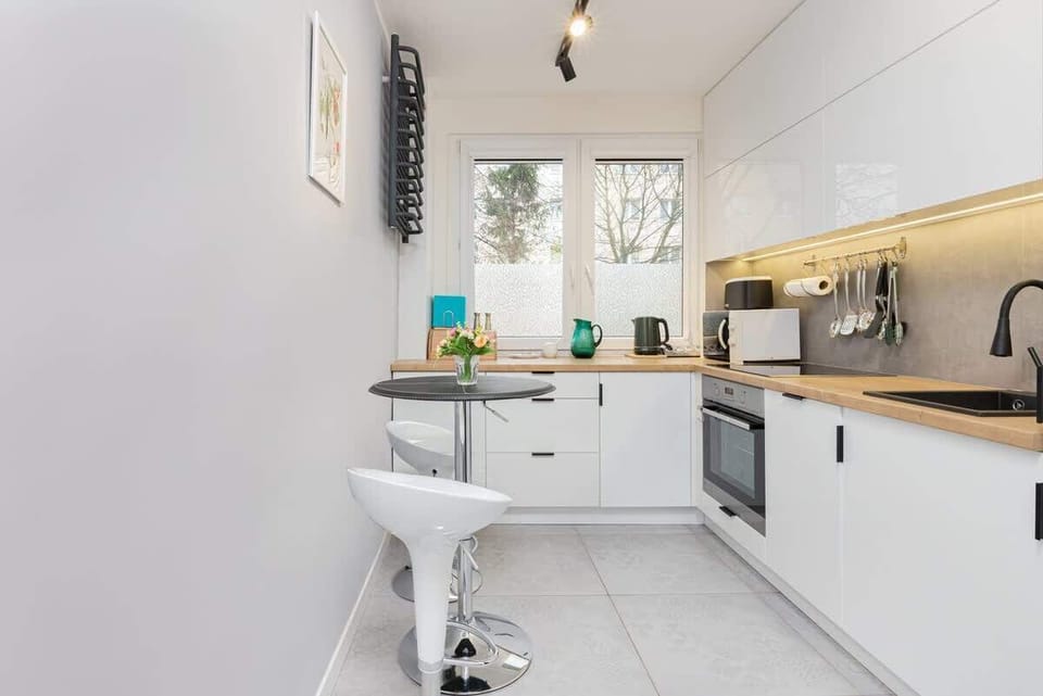 Functional kitchen with white cabinets and quality appliances that allow you to prepare home-cooked meals.