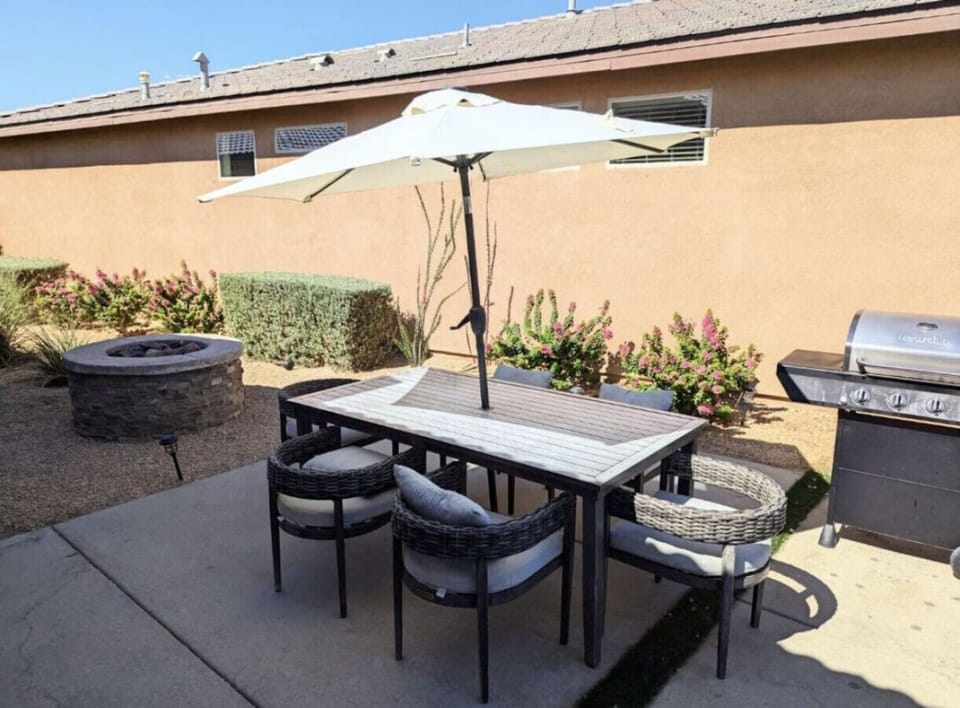 Outdoor dining area, fire pit and grill to enjoy a night eating in