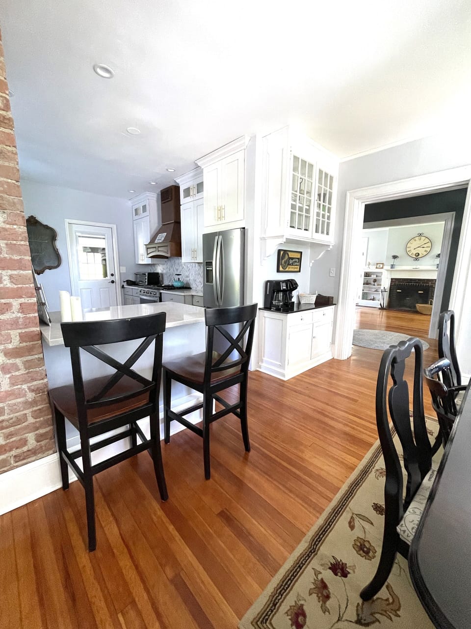 View of downstairs hallway, kitchen and dining area with coffee bar