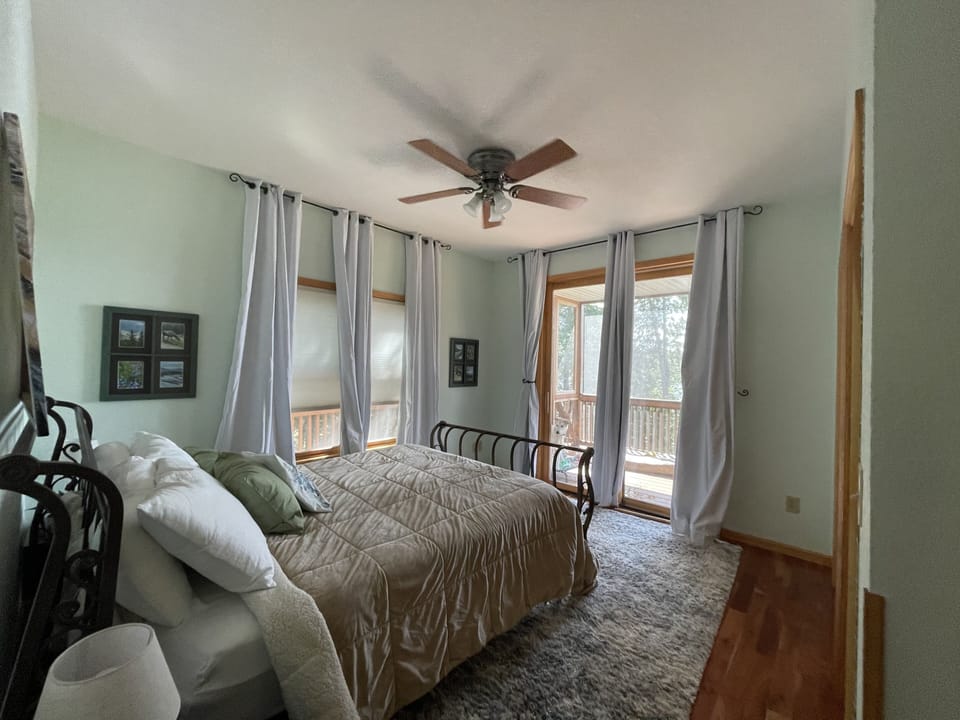 Main Level Bedroom (queen size bed) access to the screen porch/deck.