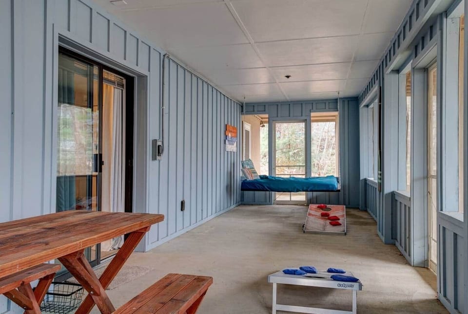 Master Porch with games, swing bed and picnic table