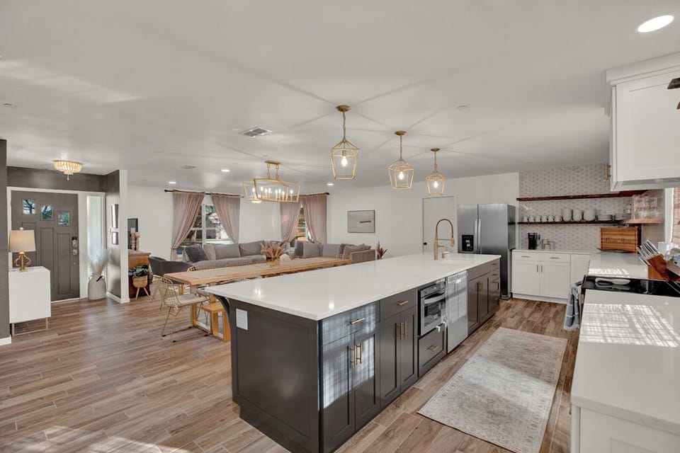 The kitchen is fully stocked with indoor and outdoor plates and glasses. 