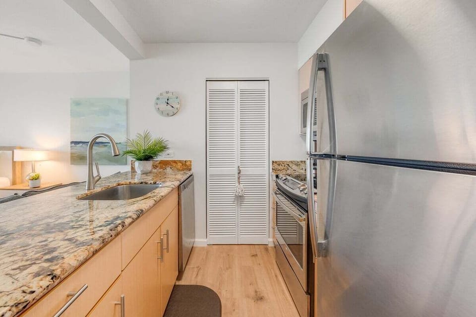 A well-equipped kitchen with granite surfaces, ample storage, and a stainless steel appliances